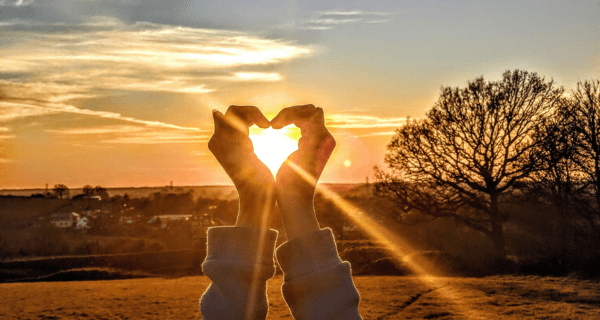 park sunset hands in heart shape - Holistic Divinity