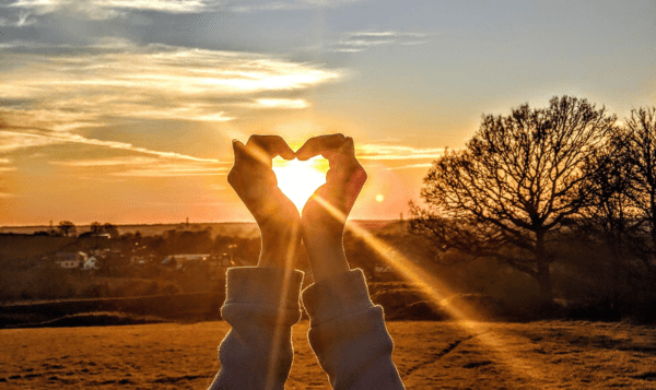 park sunset hands in heart shape - Holistic Divinity