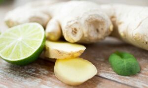 Ginger and lime laying on a wooden board